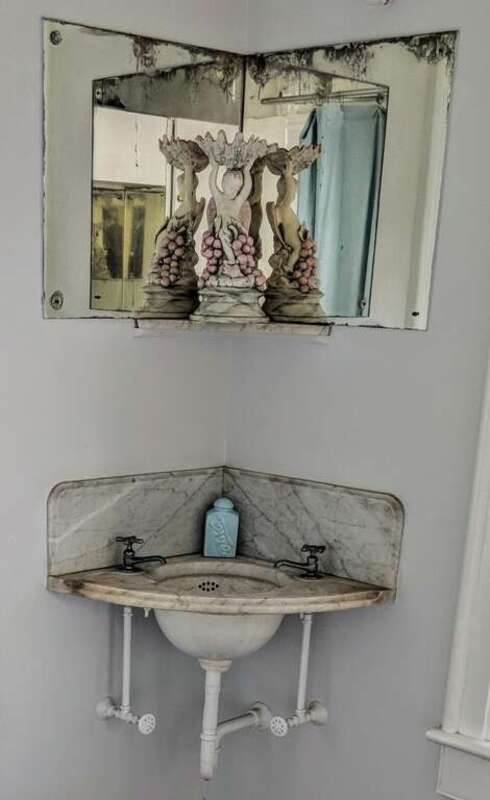 A marble vanity sink and mirrors in the Ernest Hemingway House in Key West, Florida. Photo by Jim Heaphy.