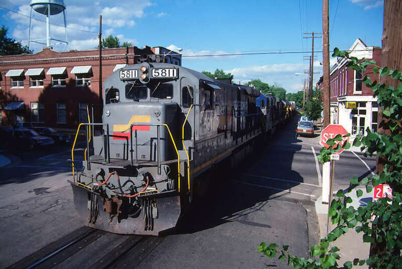 Train rolling westbound along Main Street in La Grange, Kentucky, USA. (Scan from 35mm slide.)