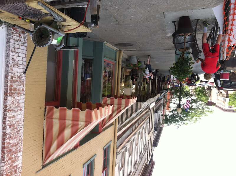 Evan McArthur on his bike waiting for parents remodeling work on Main in Hannibal, MO