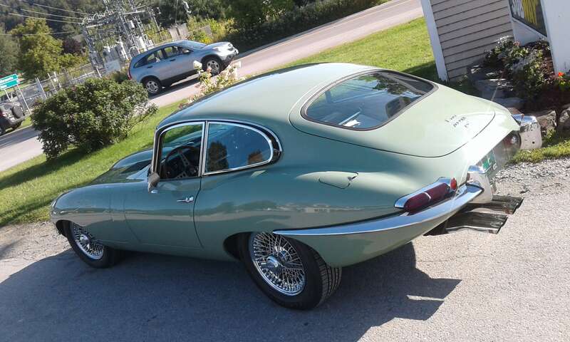 Jaguar E-Type coupe at ExxonMobil gas station on VT Rte 15 in Morrisville, Vermont (rearview).
