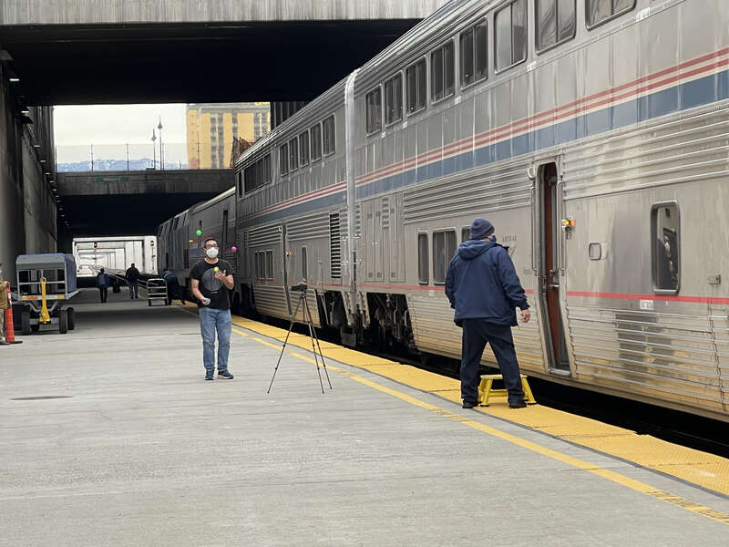 An Amtrak California Zephyr patron juggling during a fresh air break at Amtrak Train Station Reno.