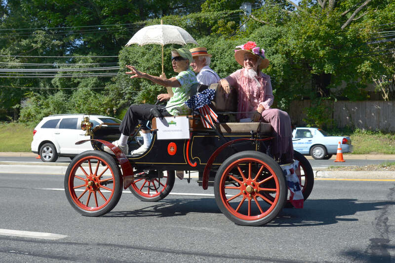 An old car with the grand Marshal at the start of the Kensington, Maryland 2014 Labor Day Parade.