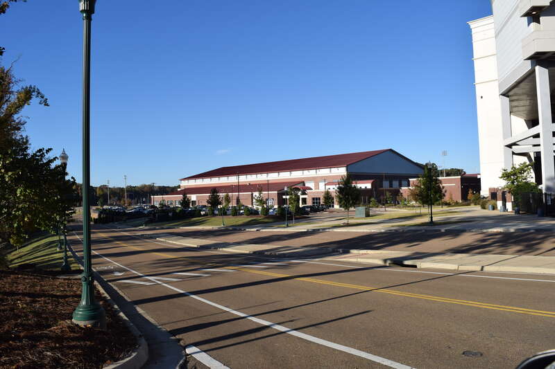 Manning Way with bike lanes and sidewalks with the Olivia and Archie Manning Athletics Performance Center in the background and Vaught-Hemingway Stadium at right