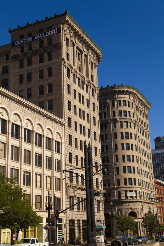 The Newhouse Building, behind the Boston Building, in Salt Lake City, Utah, USA.