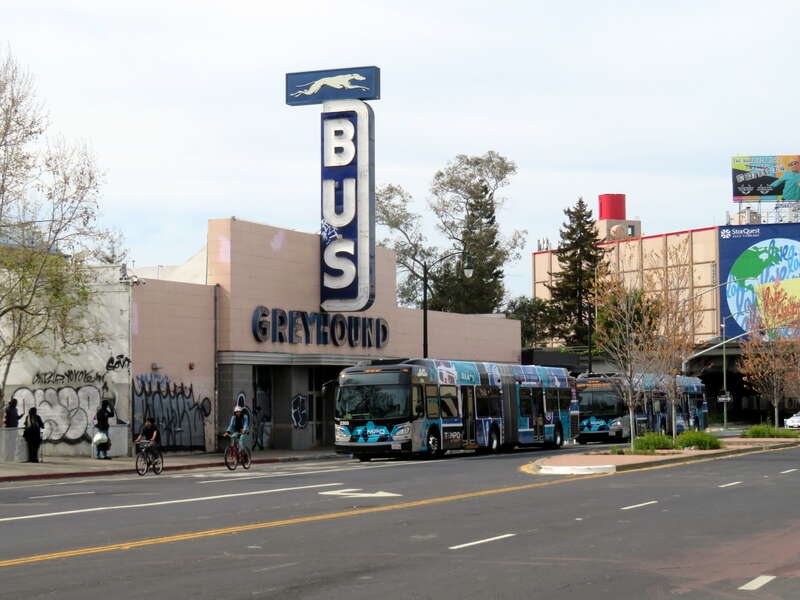Tempo buses laying over in front of the Oakland Greyhound station in April 2021