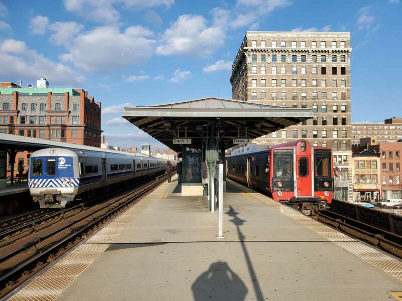Two trains at Harlem–125th Street station in December 2021. At right is a New Haven Line train to Stamford; at left is a Hudson Line train from Croton-Harmon to Grand Central.