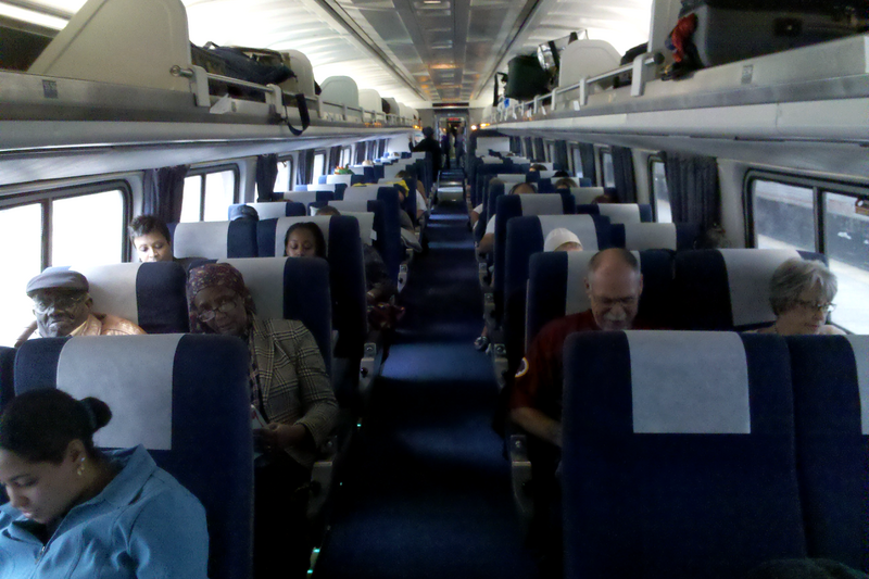 Passengers riding on board the first coachclass car behind the Cafe Lounge car on the westbound Cardinal train, September 21, 2011.

Ben Schumin is a professional photographer who captures the intricacies of daily life.  This image may be used under