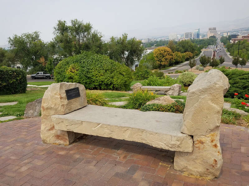 The Donna Beth Richmond bench and a view of downtown Boise, Idaho, from Platt Gardens at Boise Depot.