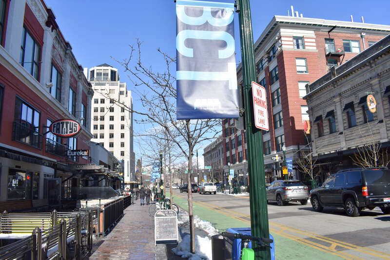 A view of N 8th St from 8th and Idaho Sts in Boise, Idaho, shows the Hotel Boise farther at left and the Idaho Building and Federal Building in the distance at right.