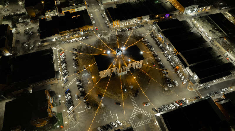 The Lafayette County Courthouse still decorated for Christmas 2021 as patrons park to visit the local nightlife.