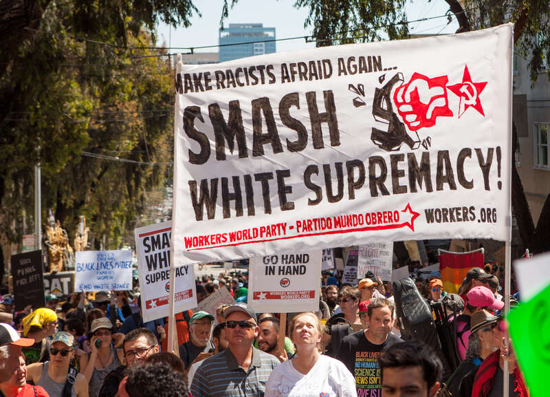 Protesters hold a Workers World Party banner reading &quot;Make Racists Afraid Again... Smash White Supremacy!&quot; at a Patriot Prayer counter-protest in San Francisco.