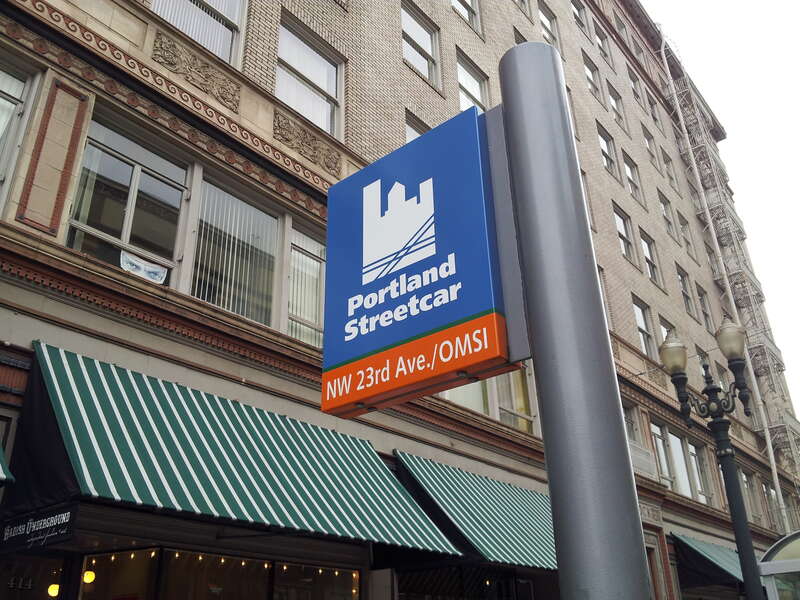 Sign at Portland Streetcar stop at SW 10th and Stark, in 2014, showing the destinations of the two streetcar lines serving the stop at that time (NW 23rd Avenue for the NS Line and OMSI for the CL Line).