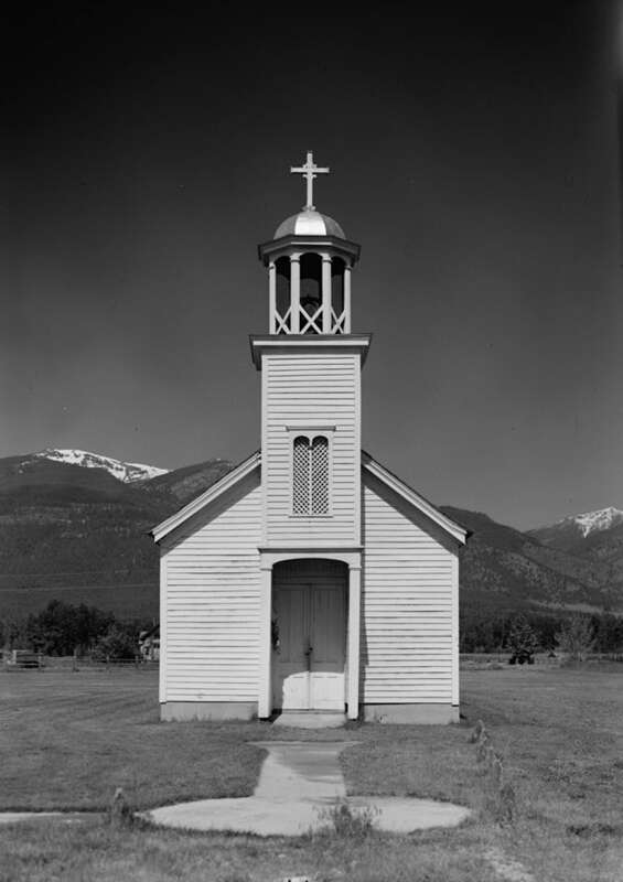 Front view of St. Mary's Roman Catholic Mission, located along North Avenue in Stevensville, Ravalli County, Montana, United States.  Together with an attached pharmacy, the church (built in 1866) is listed on the National Register of Historic Places