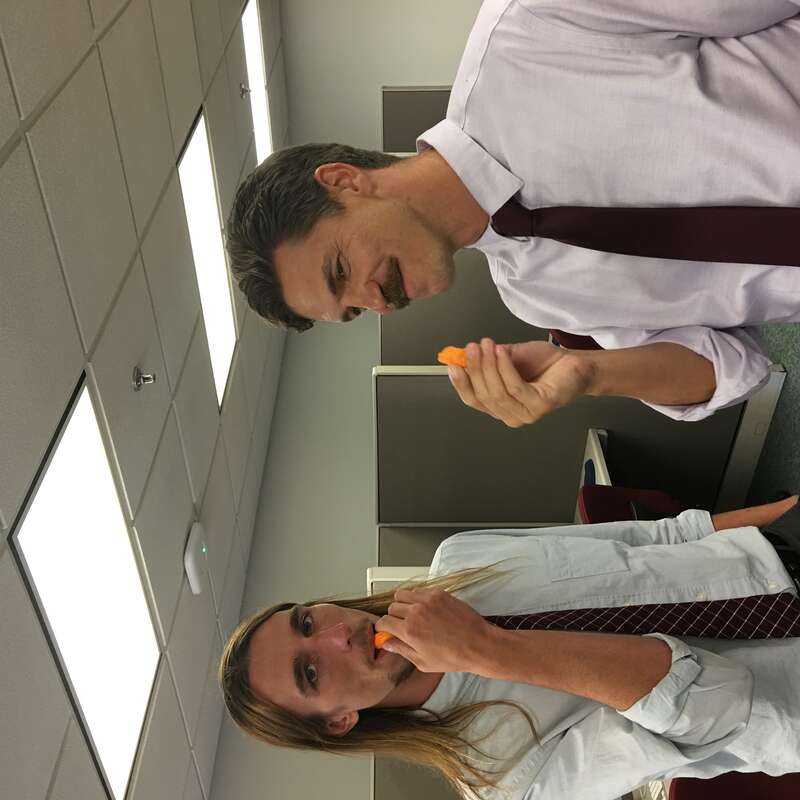 Two academics celebrate a dissertation proposal defense with circus peanuts