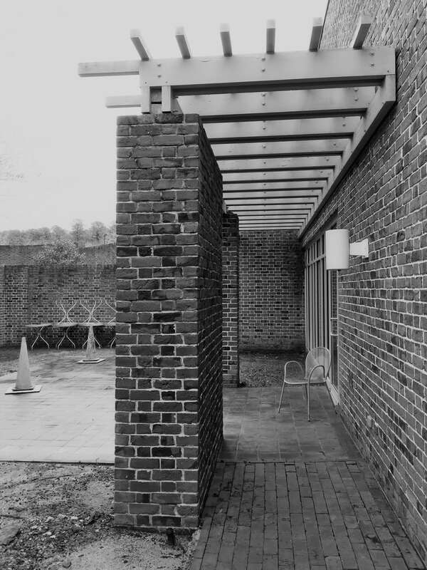 An empty chair overlooking the Courtyard of Philanthropy at the Colonial Williamsburg Regional Visitor Center.