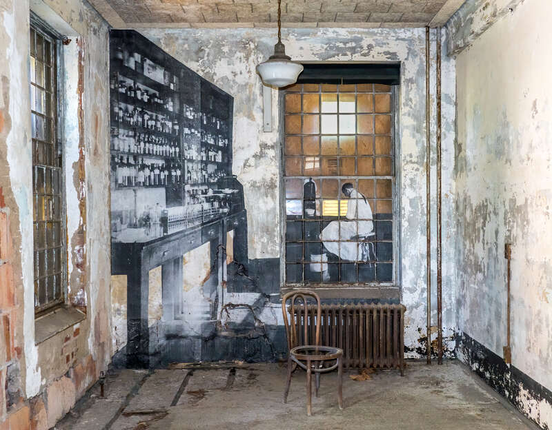 A hospital room in the Ellis Island Immigrant Hospital, closed since 1930. The photograph is one from the early 20th century, when the hospital was operational. In 2014 the French artist JR put up large reproductions of such photographs around the