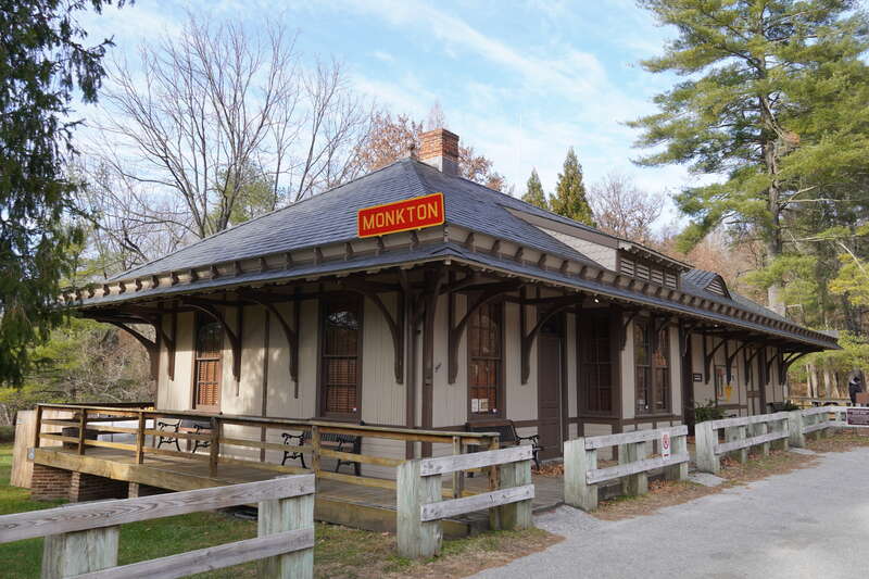 Monkton railroad station, three quarters view; red sign reading &quot;MONKTON&quot; is visible