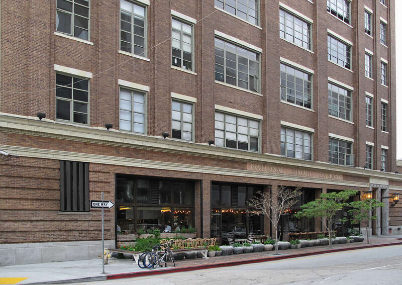 View of the National Biscuit Company Building, 1850 Industrial Street, Los Angeles from the corner of Mateo Street. It has been renovated into lofts, with a restaurant on the ground floor.