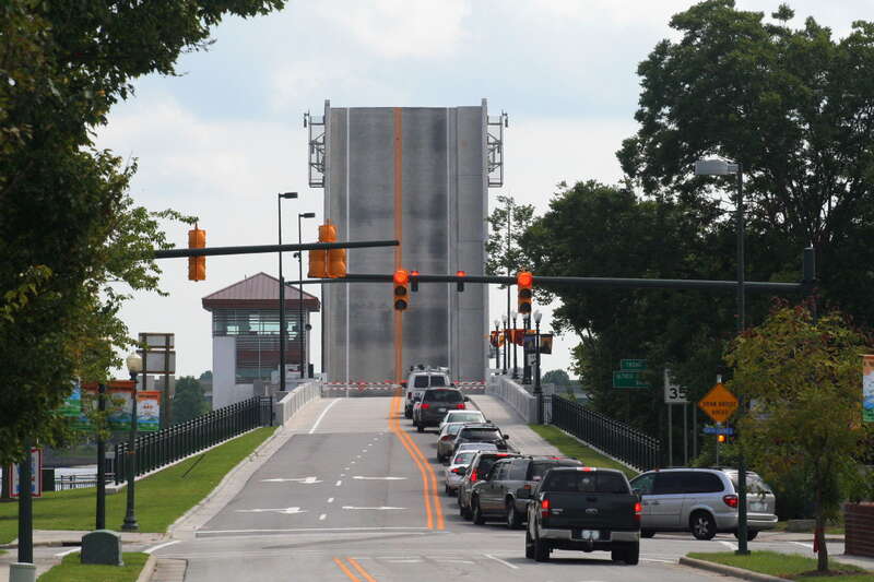The new Alfred Cunningham Bridge (across the Trent River in New Bern, North Carolina) with its bascule-type lift span raised for a ship to pass through, and traffic waiting for it to come back down.  The current bridge is a 2010 double-leaf bascule