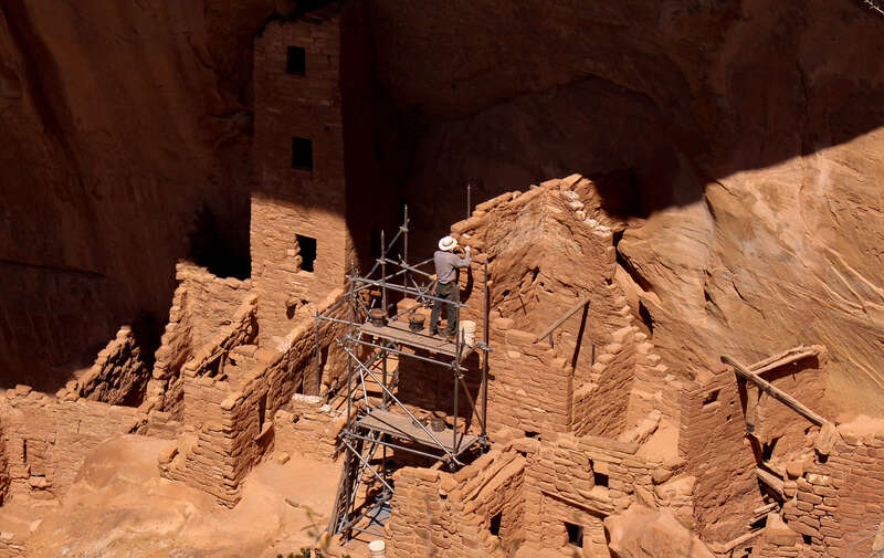 500px provided description: A park ranger works on restoration of one of the cliff dwellings in Mesa Verde National Park in Colorado. [#park ,#architecture ,#rocks ,#colorado ,#structure ,#mesa verde ,#pueblo ,#relic ,#pueblos ,#restoration ,#park