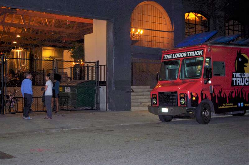 A late night group hang out at the entrance to the Iron Triangle Brewery in the Arts District of Los Angeles. This brewery among several others  the arts District could also be the &quot;Brewery District&quot;  !