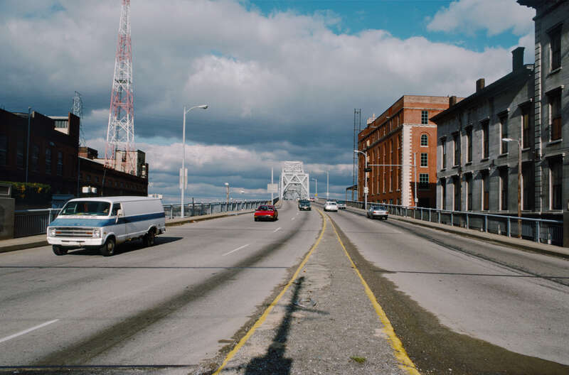 Looking N from median of Kentucky approach to Clark (2nd St.) Bridge, just N of Main St..
At left, LG&amp;amp;E Waterside Station .
Brick building at right is Belknap warehouse being converted to offices for Presbyterian HQ.
Louisville, Kentucky.
Dec.