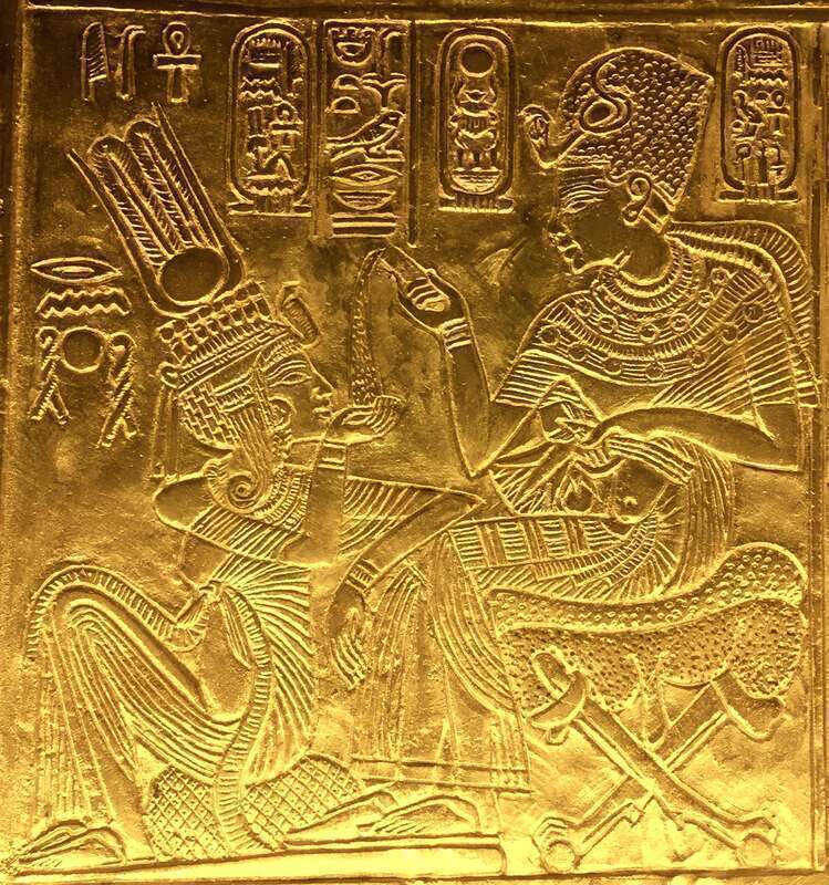 Scene from the golden shrine of Tutankhamun. King and Queen are seated and Tutankhamun seems to pour ointment on Queen's hand.