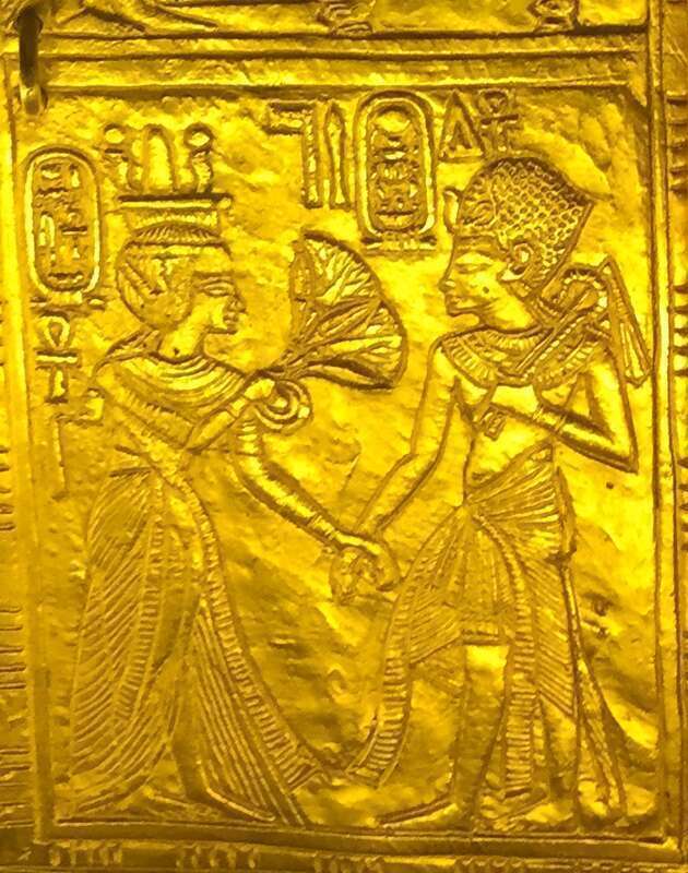 Scene from gilded shrine of Tutankhamen showing him and his wife Queen Ankhesenamun. Queen offers flowers to the King