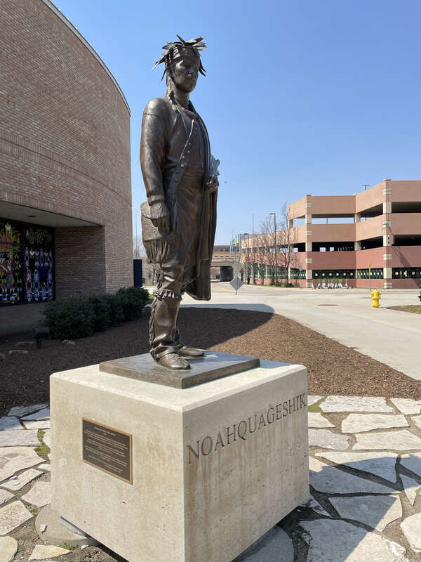Statue of Chief Noahquageshik along the Grand River in Grand Rapids, Michigan