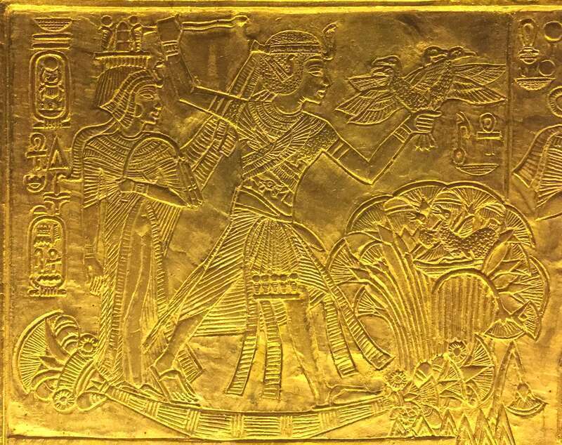 Scene from gilded shrine of Tutankhamen showing him and his wife Queen Ankhesenamun. Closeup showing Tutankhamun and Ankhesenamun hunting ducks in the marshes.