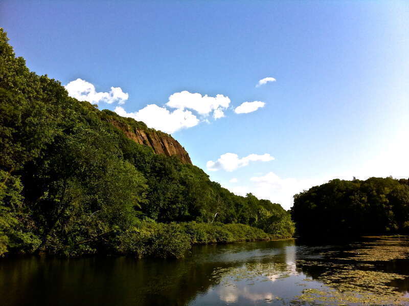 A view of East Rock in New Haven, CT from a bridge in the park
