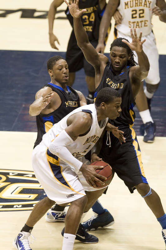 Edward Daniel (MSU) being defended by Demonte Harper and Kenneth Faried (Morehead State)