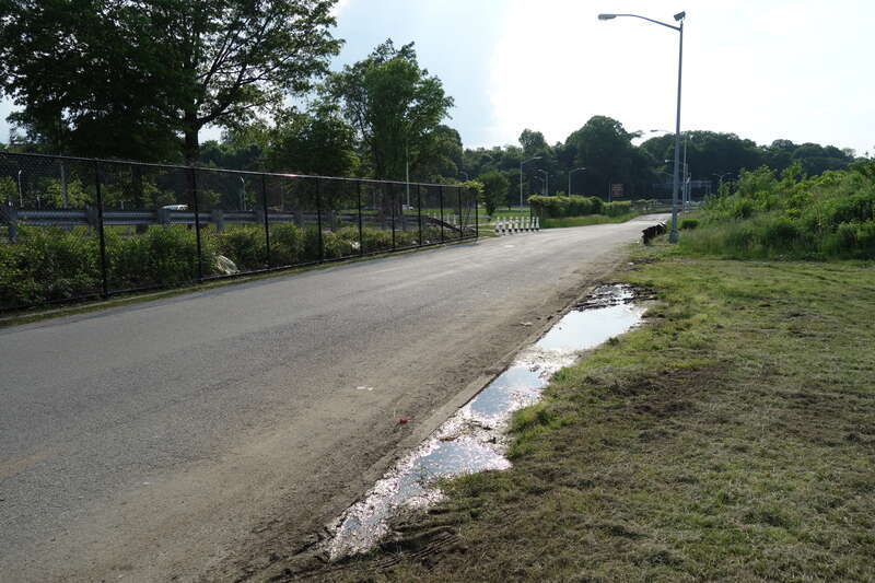 Looking north up Meadow Lake Drive next to the Grand Central Parkway in the Meadow Lake section of Flushing Meadows–Corona Park, on Meadow Lake Drive near Jewel Avenue / 69th Road between Forest Hills and Queensboro Hill, Queens.