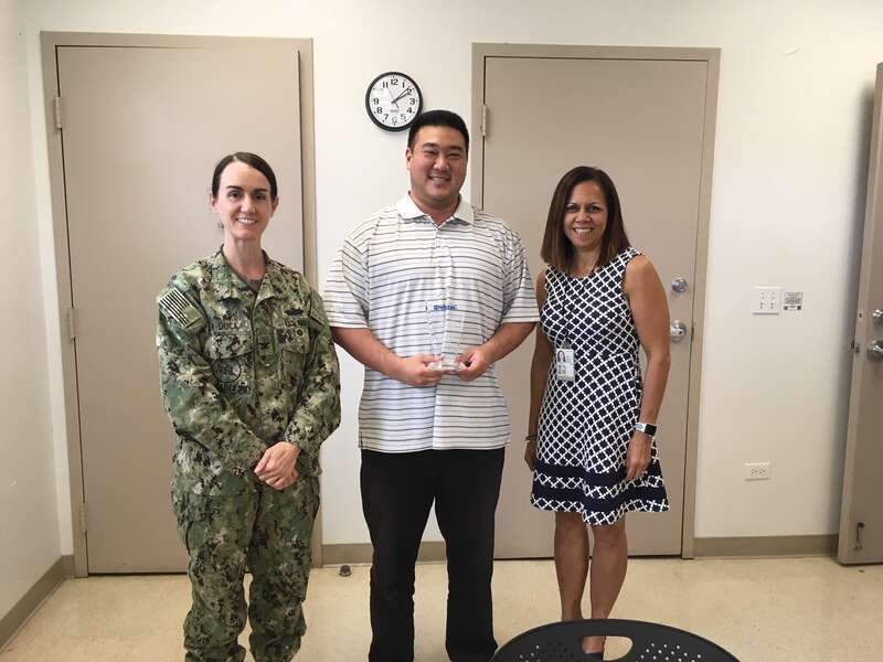 (L-R) NAVFAC Pacific Vice Commander Capt. Michelle LaDuca presents Asset Management employee Jasen Hee (AM42) Feb. 26 with the Employee of the Quarter Award for the 4th Quarter of 2017. Vanessa Simpkins, Hee's supervisor, is also pictured in support