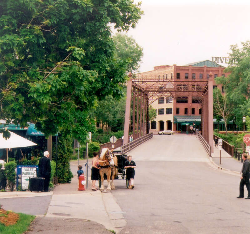 Visitors get ready for a ride in a horsedrawn carriage near the Nicollet Island Inn. Nicollet Island, Minnesota. The Hitching Co., based out of Minneapolis provides these rides daily throughout the summer.