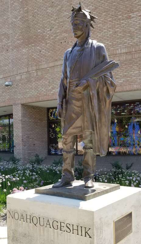 Bronze statue of Noahquageshik sculpted by Antonio Tobais Mendez in 2010. The statue is adjacent to Grand Valley State University's Eberhard Center and near the Grand River in Grand Rapids, Michigan.