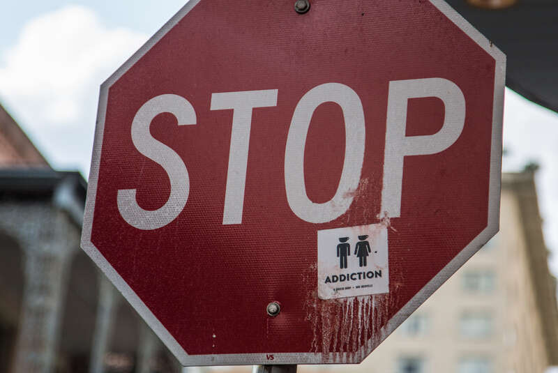 Addiction Coffeehouse sticker on stop sign - New Orleans, Louisiana