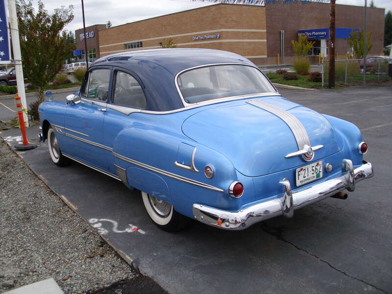 1952 Pontiac Chieftain 2-door sedan on a used car lot, asking $13,995. Nice looking car. I wonder if what is under the hood is original?