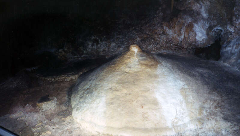 As the dripping groundwater dissolves the limestone, it is deposited along the bottom of the cavern and builds there. This kind of formation is called a stalagmite.
And as for the icicle-shaped formation on the ceiling where the limestone builds up