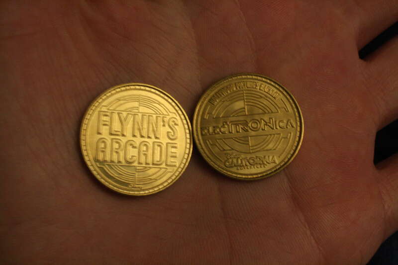 This is a Flynn's Arcade ElecTRONica token from Disney's California Adventure Park. I am on the other side of the country so I purchased these from ebay.

These tokens are used at the arcade in promotion to the new Tron Legacy movie coming out