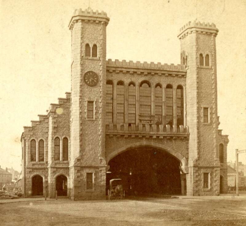 Stereo view of the Eastern Railroad depot in Salem, Massachusetts, at the end of Washington Street. A horse-drawn carriage is visible in the center under the station's granite archway.