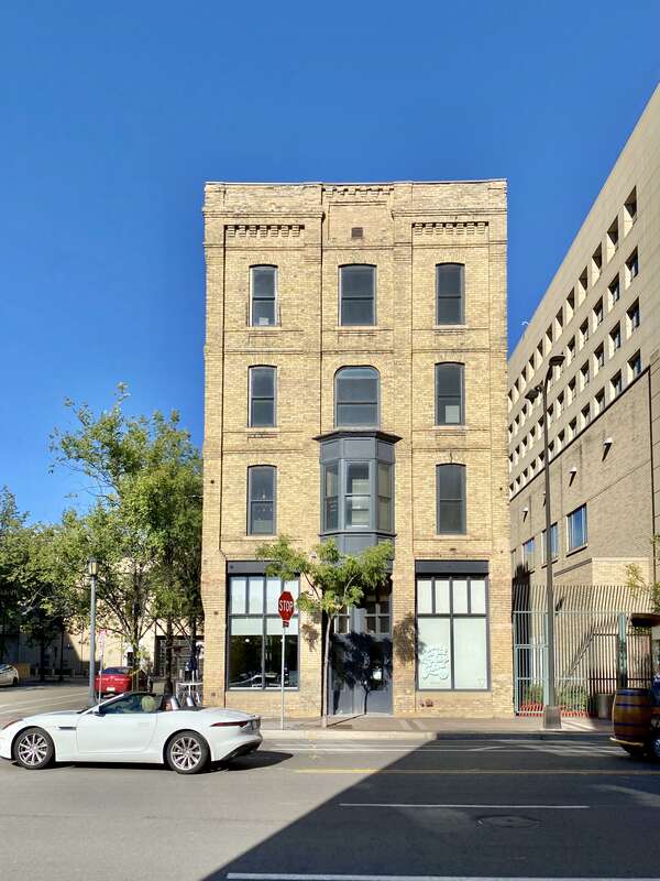 Built in 1888, this buff brick Italianate-style building was formerly known as the Market Hotel, a boarding house.  The building features brick pilasters, corbeling at the roofline and base of the second floor, arched window openings, a second-story