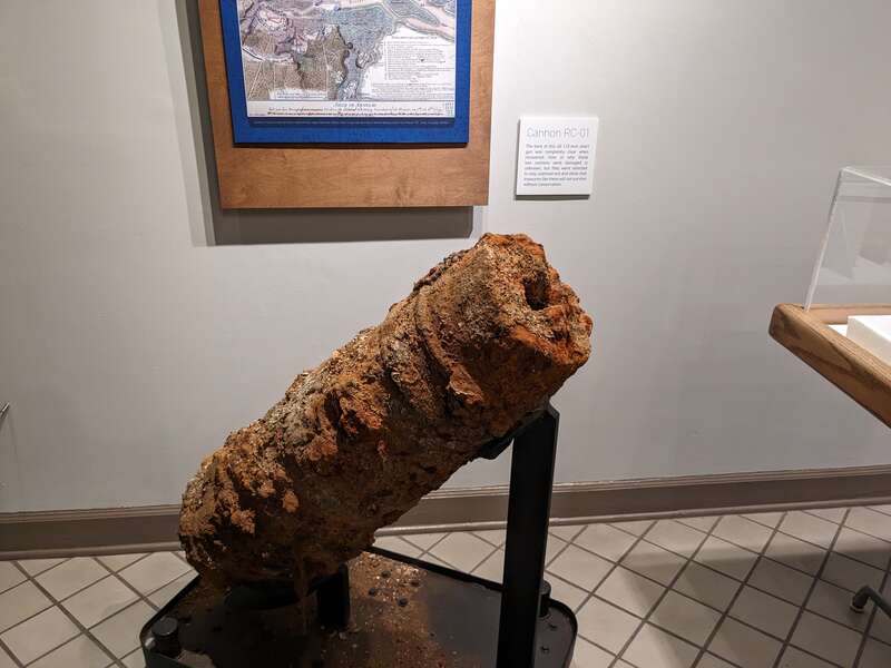 A river-damaged cannon, labelled &quot;RC-01&quot;, intentionally un-conserved