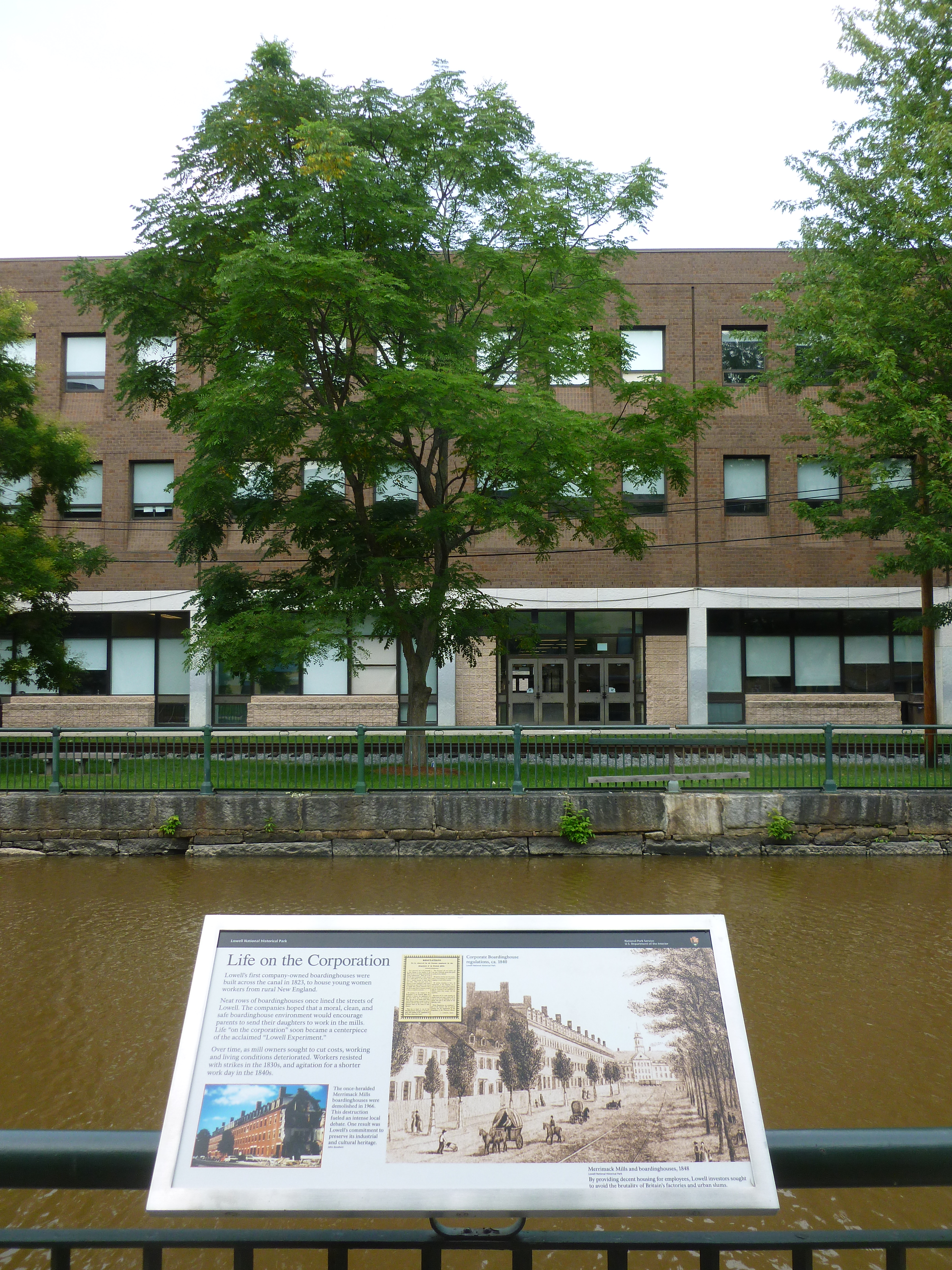 'Life on the Corporation', a panel describing life in company-owned boardinghouses in the first half of the 1800's.  Located in Lucy Larcom Park,  part of the Lowell National Historical Park, near Merrimack Street in Lowell, Massachusetts. The