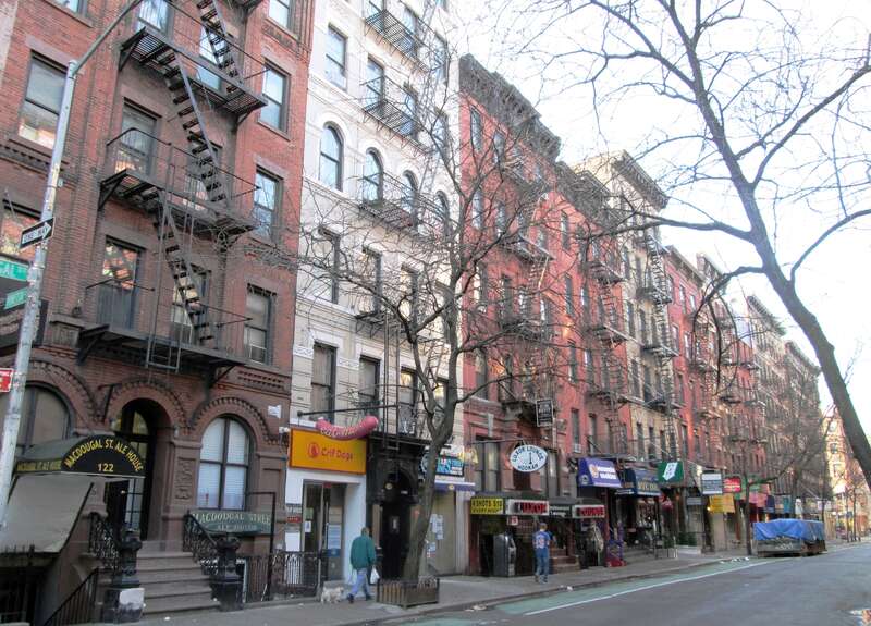 The east side of MacDougal Street below the intersection with Minetta Lane in the South Village neighborhood of Greenwich Village, Manhattan, New York City is located within the South Village Historic District.