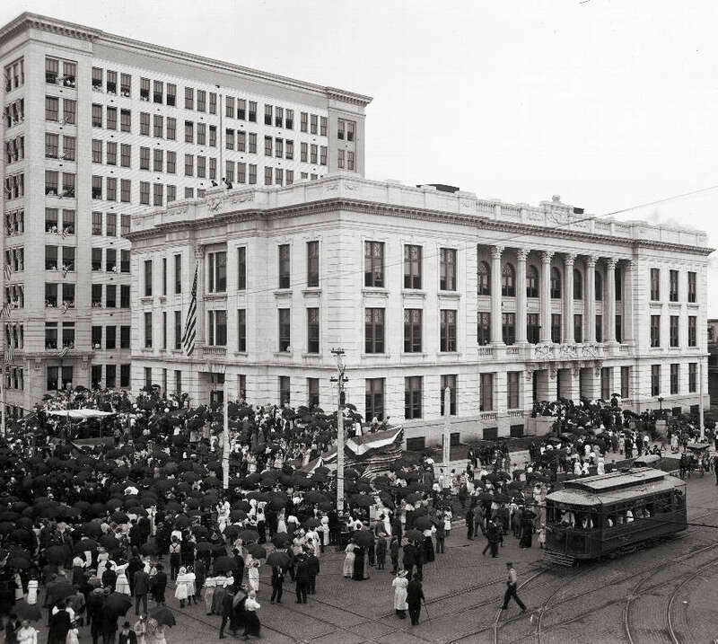 People watching a parade during the dedication ceremonies of the Grand Army of the Republic's Memorial Hall located in Topeka, Kansas.  Landon State Office Building is in the background.