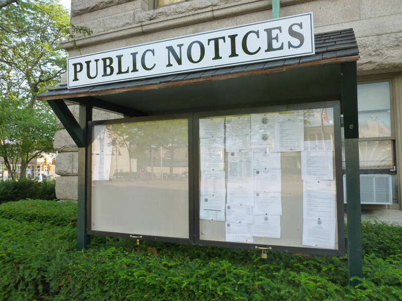 Public Notices board on north side of Lowell City Hall.