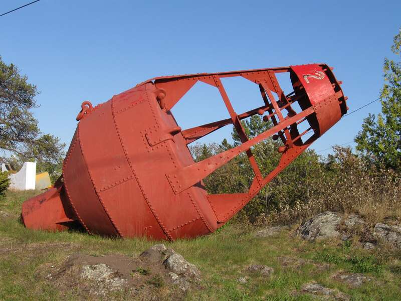 An old style riveted bell buoy without the bell at Eagle Harbor in Michigan, USA. This bell buoy is 8 feet wide, 13 feet tall and weighs 5,000 lbs.