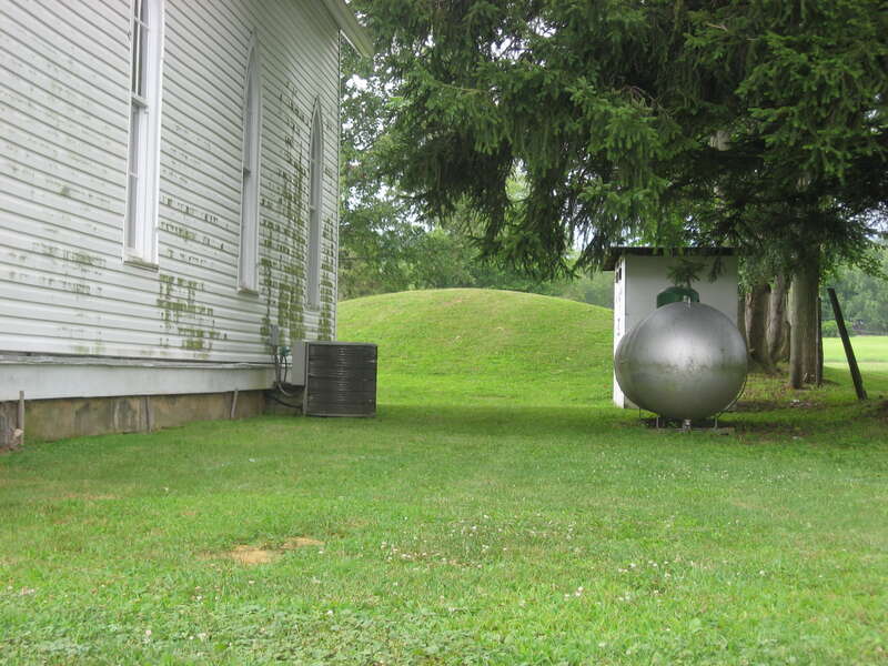 Eastern side of the Zaleski Methodist Church Mound, located at 114 Broadway Street in Zaleski, Ohio, United States.  Built by the prehistoric Adena culture, it is listed on the National Register of Historic Places.
