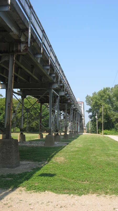Northern side of the eastern end of the Harmony Way Bridge, which carries Indiana State Road 66 and Illinois Route 14 over the Wabash River between New Harmony, Indiana and rural White County, Illinois in the United States.  Built in 1930, it is